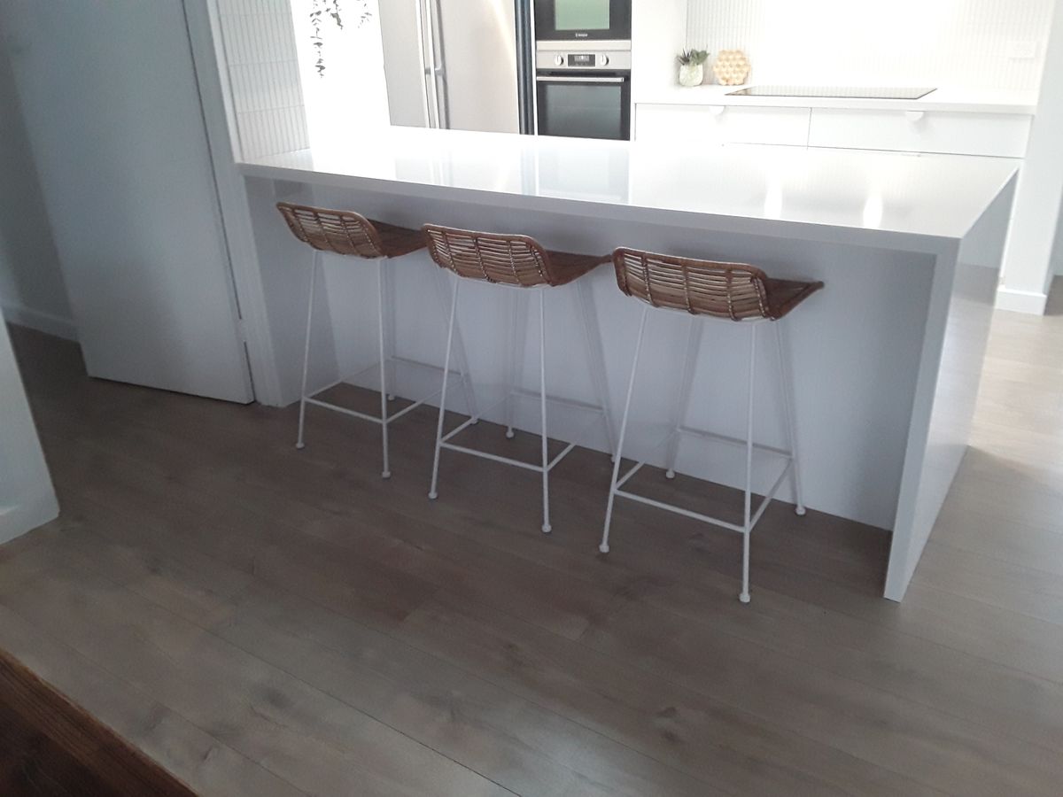 Kitchen island with rattan bar stools