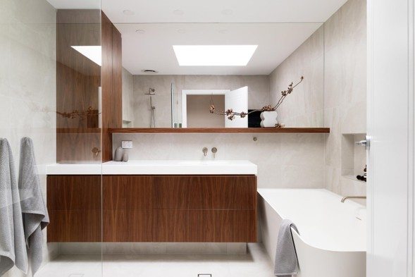 Luxury bathroom with walnut vanity and freestanding bath